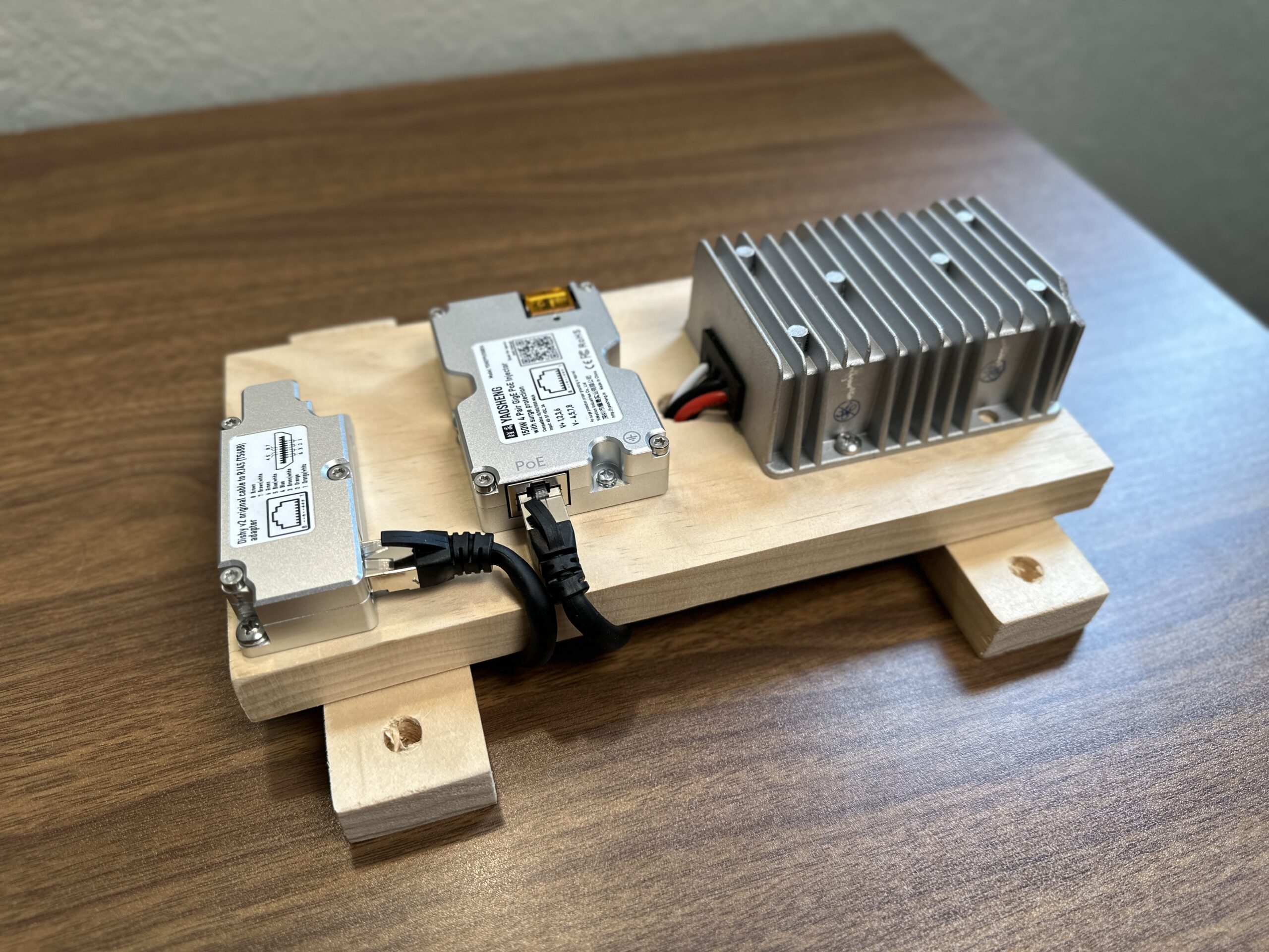 This image shows all the components of the Starlink 12V power supply screwed to a scrap piece of wood, ready for mounting in my RV.